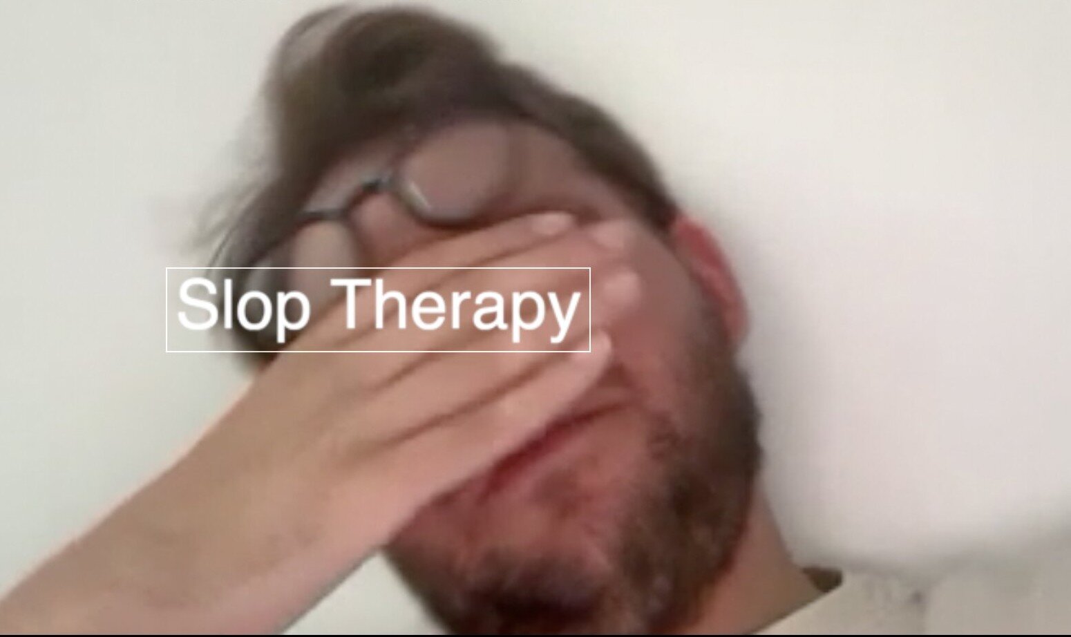 Slop Therapy still — a man covering his face in exasperation